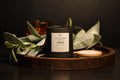 Velvet Noir Abide candle styled with sage leaves