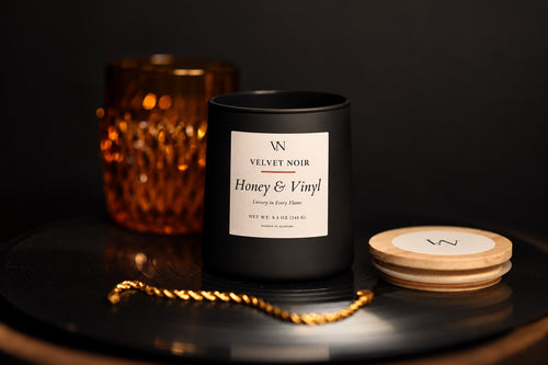 Velvet Noir Honey and Vinyl candle styled on a record